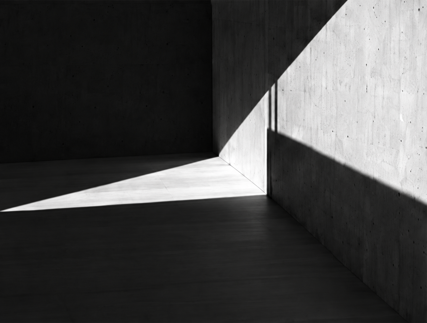 Sunlight falling across a concrete architectural space