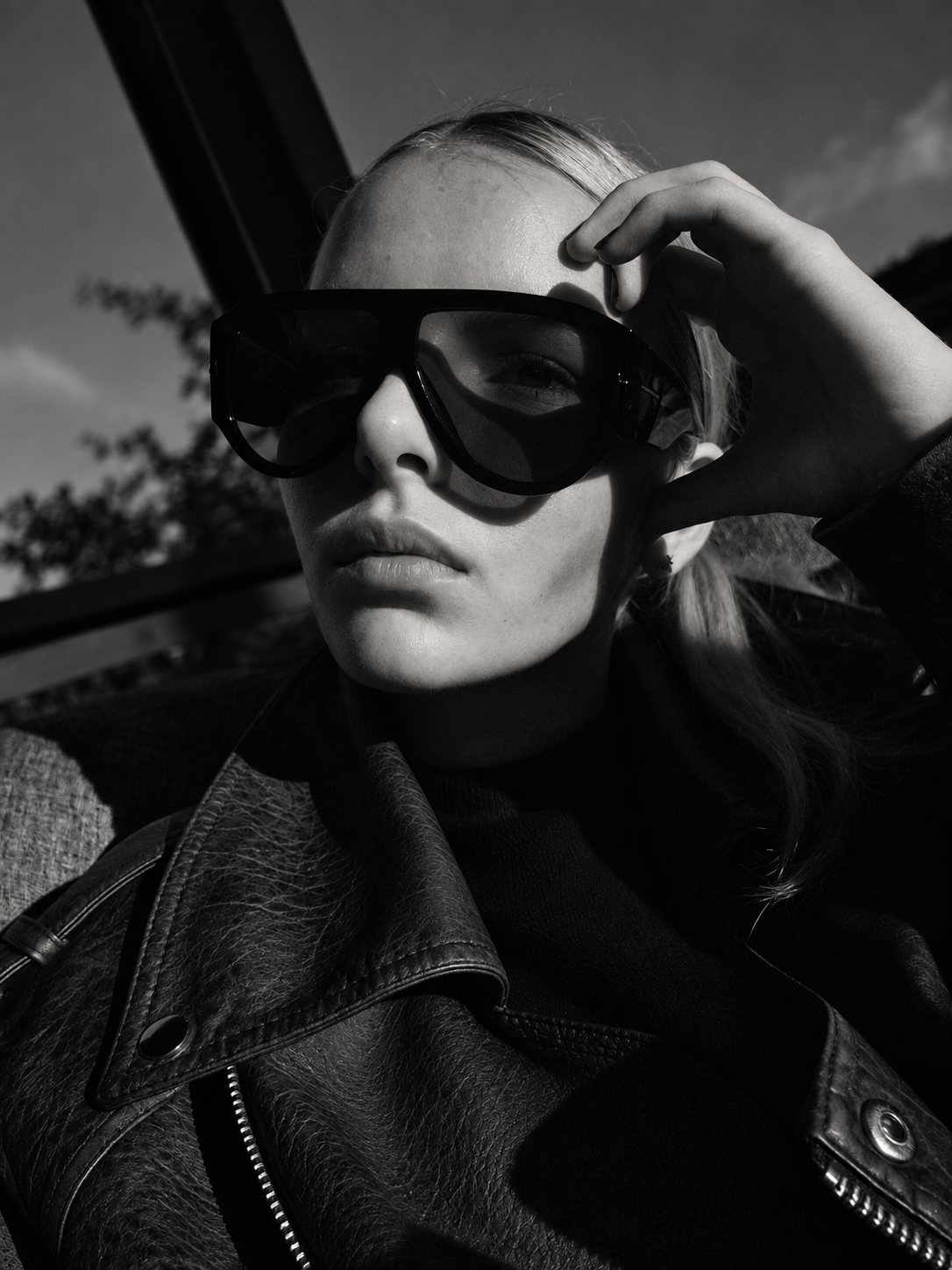Roxi in sunglasses and a leather jacket, black and white editorial portrait